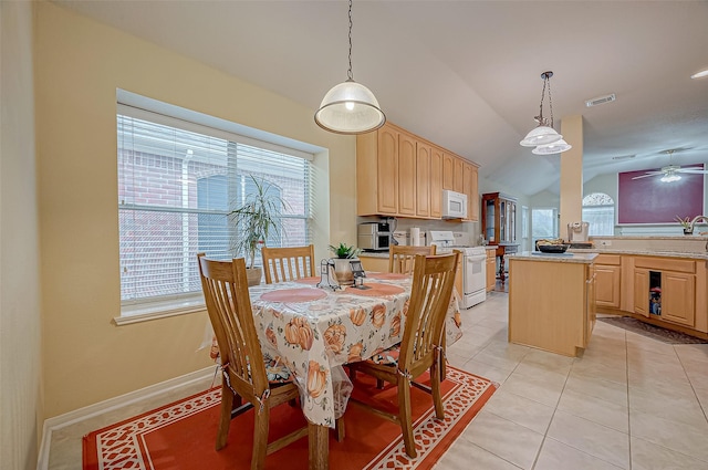 dining area with light tile patterned floors, vaulted ceiling, and ceiling fan