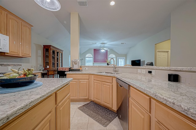 kitchen with light tile patterned flooring, light brown cabinetry, dishwasher, lofted ceiling, and sink