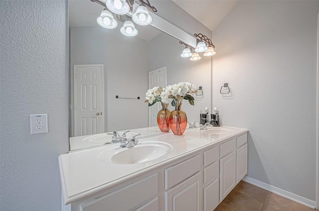 bathroom featuring tile patterned floors, vaulted ceiling, and vanity