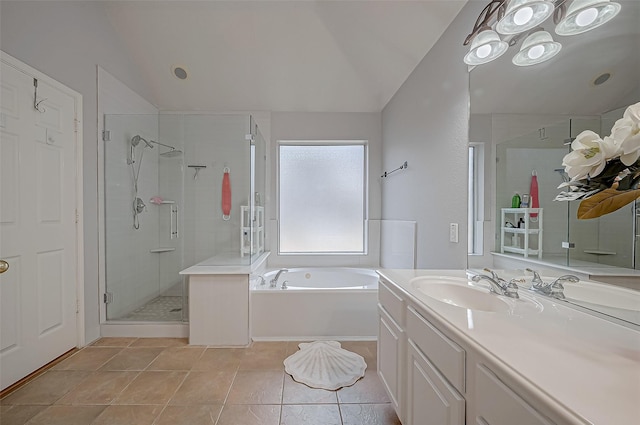 bathroom featuring tile patterned flooring, shower with separate bathtub, vaulted ceiling, and vanity