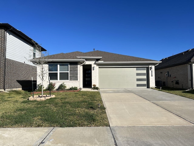 view of front of home with a front lawn and a garage