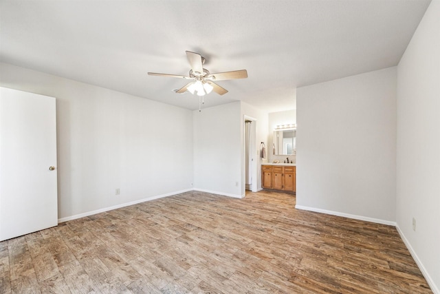 spare room featuring ceiling fan, sink, and hardwood / wood-style floors