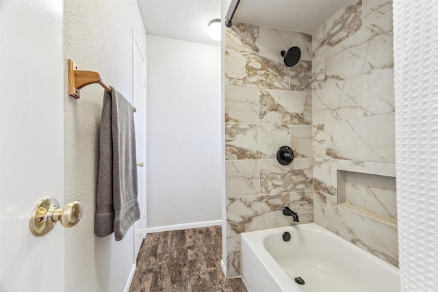 bathroom featuring hardwood / wood-style flooring and tiled shower / bath combo