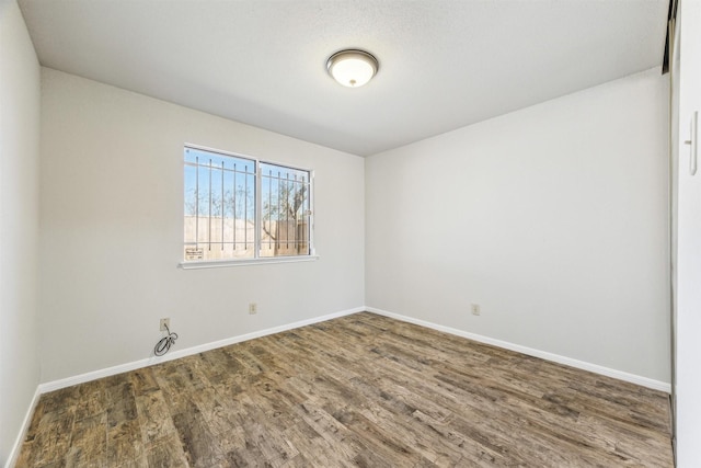 empty room featuring dark hardwood / wood-style flooring