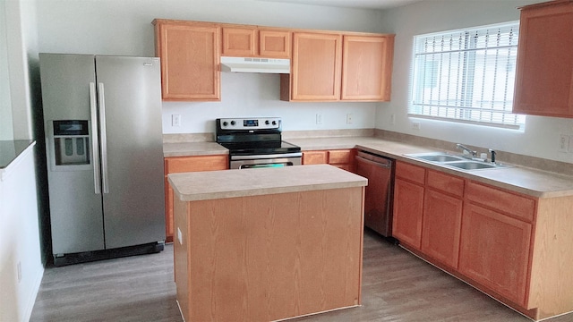 kitchen featuring sink, light hardwood / wood-style flooring, light brown cabinets, a kitchen island, and stainless steel appliances