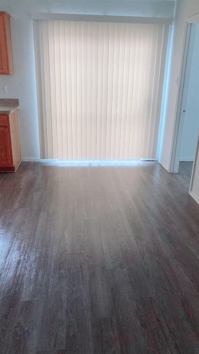 unfurnished living room featuring dark wood-type flooring