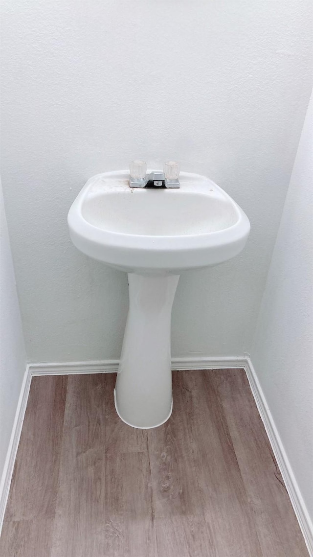 bathroom with hardwood / wood-style flooring and sink