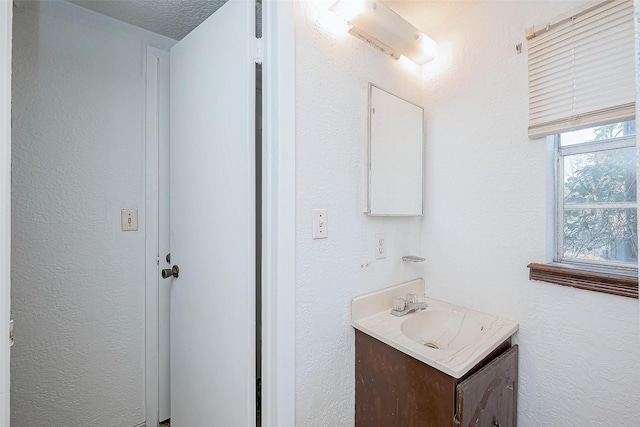 bathroom featuring vanity and a textured ceiling