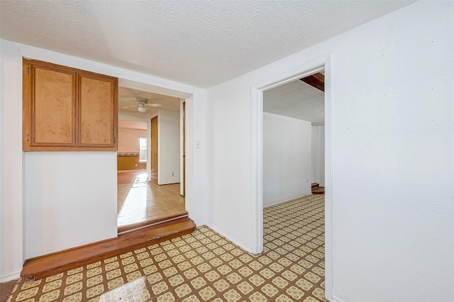 corridor featuring a textured ceiling