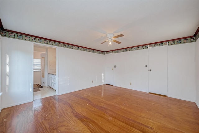 unfurnished room with ceiling fan and light hardwood / wood-style flooring