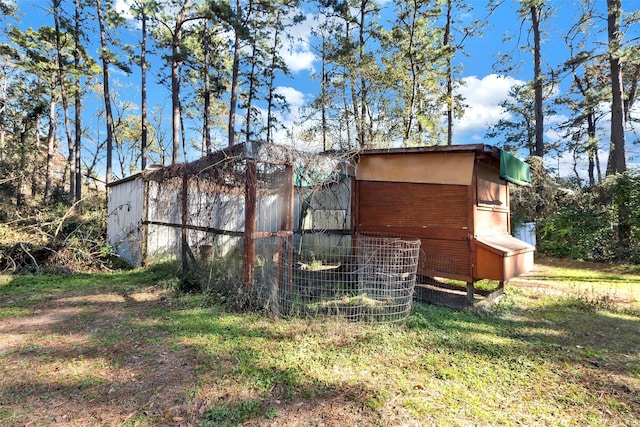 view of property exterior featuring an outdoor structure and cooling unit