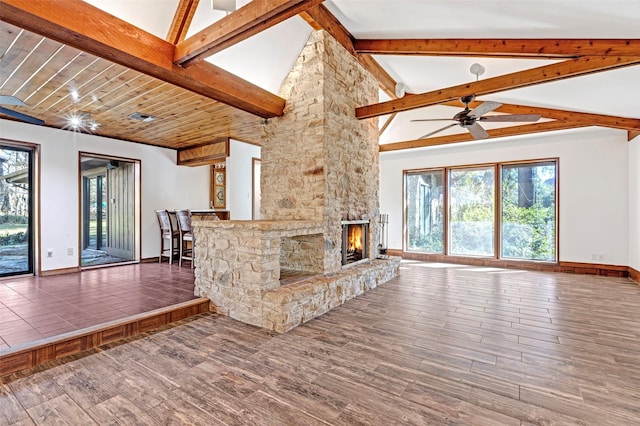 unfurnished living room featuring beamed ceiling, ceiling fan, a fireplace, and high vaulted ceiling