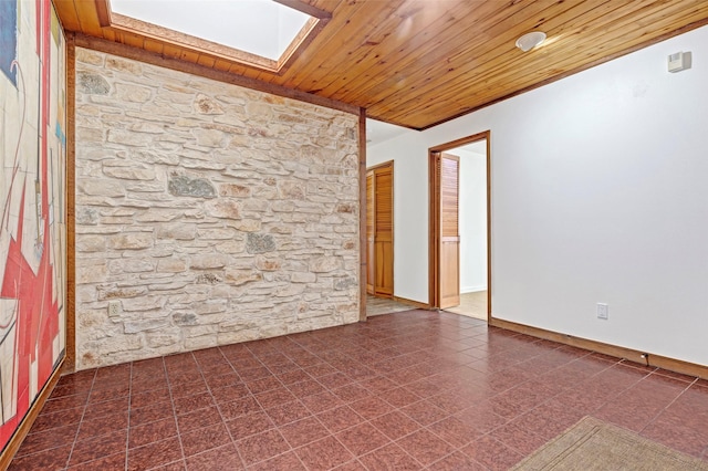 empty room with wooden ceiling, a skylight, and baseboards