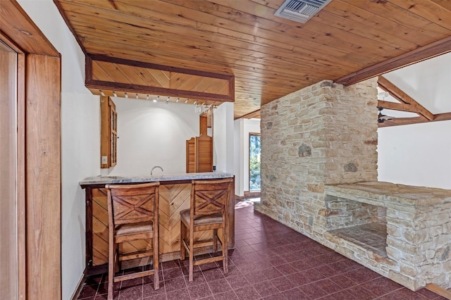 bar with wet bar, wood ceiling, visible vents, and vaulted ceiling