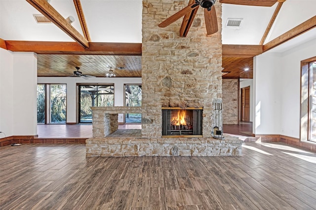 unfurnished living room with beamed ceiling, ceiling fan, a fireplace, and hardwood / wood-style flooring