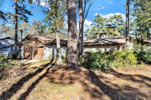 view of side of home featuring a chimney