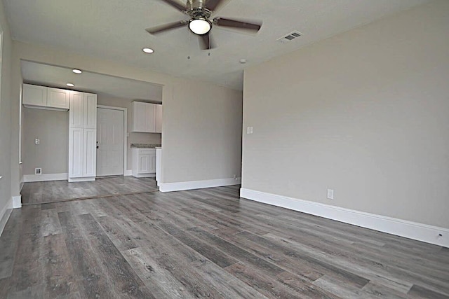 unfurnished living room with hardwood / wood-style flooring and ceiling fan