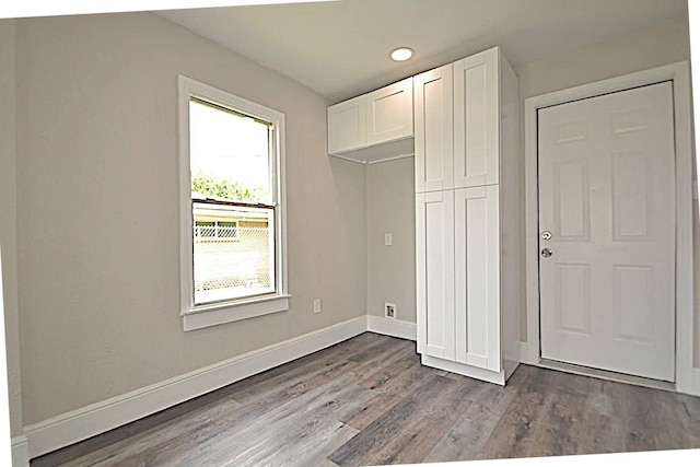 unfurnished bedroom with light hardwood / wood-style floors and a closet