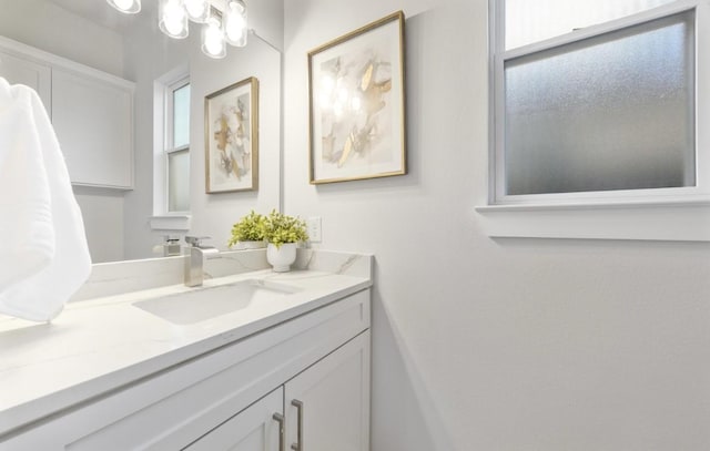 bathroom with vanity and a notable chandelier