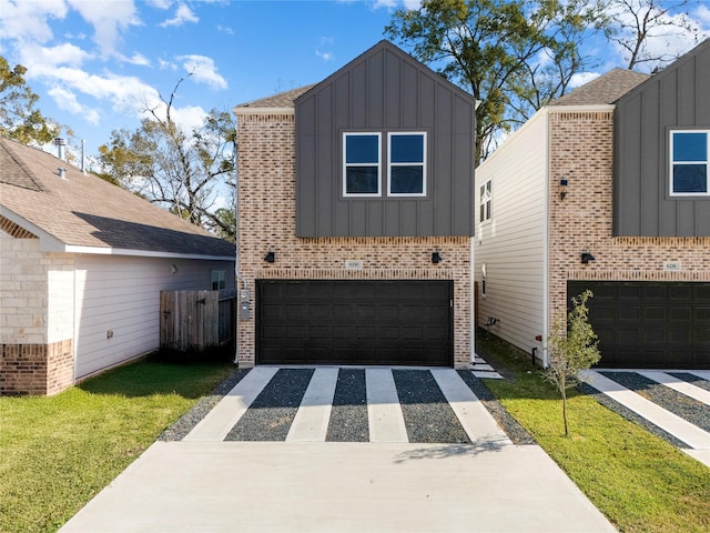 view of front of home featuring a garage and a front lawn