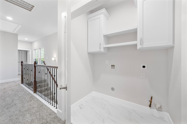 washroom featuring gas dryer hookup, electric dryer hookup, hookup for a washing machine, cabinets, and light carpet