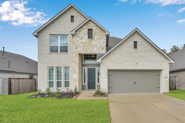 view of front of home with a garage and a front lawn