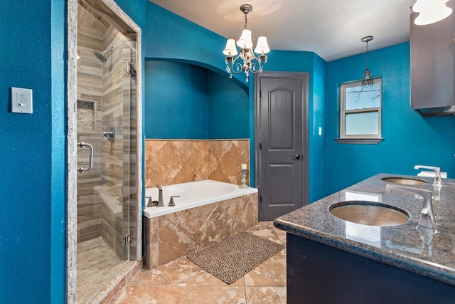 bathroom with vanity, a textured ceiling, a chandelier, and separate shower and tub