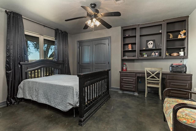 bedroom featuring built in desk, ceiling fan, and a closet