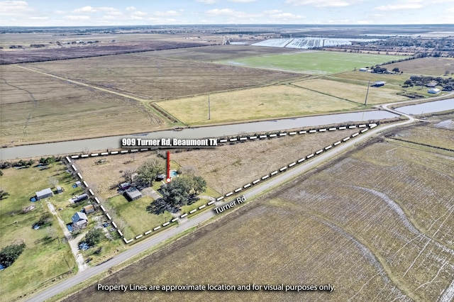 birds eye view of property featuring a rural view and a water view