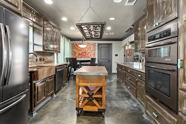 kitchen featuring crown molding, stainless steel appliances, tasteful backsplash, a kitchen island, and decorative light fixtures