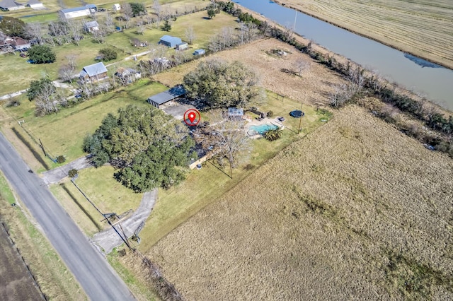 birds eye view of property featuring a water view and a rural view