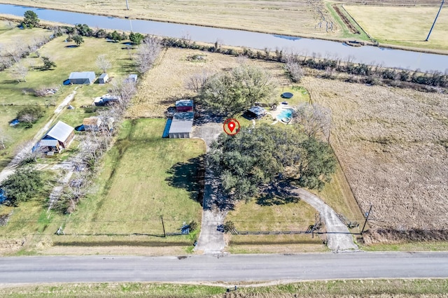 birds eye view of property featuring a water view and a rural view