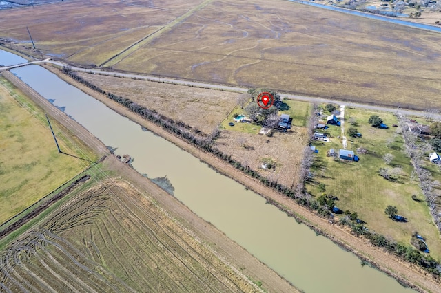 drone / aerial view with a water view and a rural view