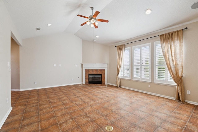 unfurnished living room with lofted ceiling, visible vents, a ceiling fan, a tile fireplace, and baseboards