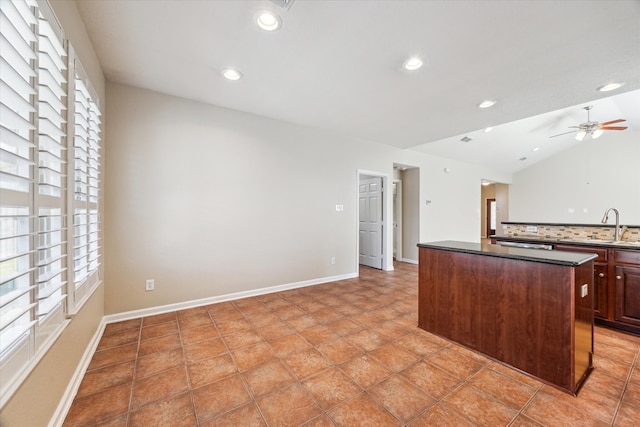 kitchen featuring tasteful backsplash, a center island, lofted ceiling, and recessed lighting