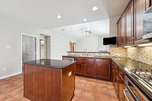 kitchen with a center island, decorative backsplash, vaulted ceiling, a sink, and a peninsula