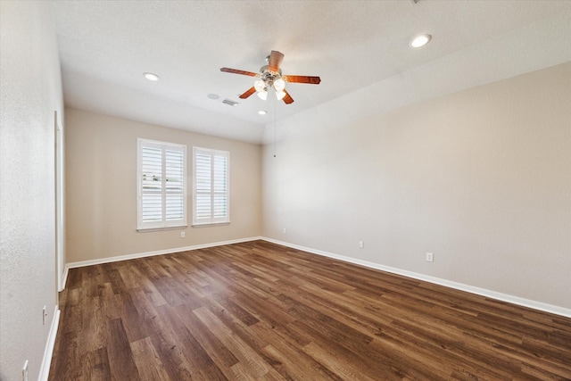 unfurnished room with dark wood finished floors, recessed lighting, visible vents, a ceiling fan, and baseboards