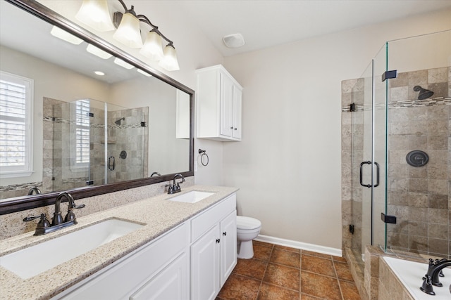 bathroom featuring a stall shower, a sink, and baseboards