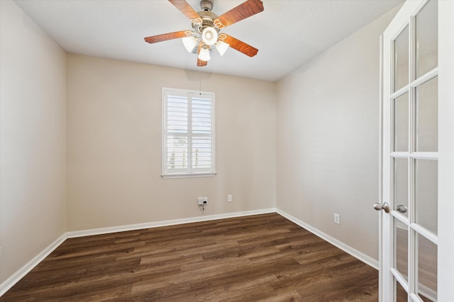 unfurnished room featuring dark wood-style floors, baseboards, a ceiling fan, and french doors