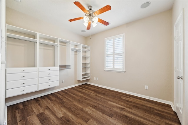 interior space with dark wood-type flooring and a ceiling fan