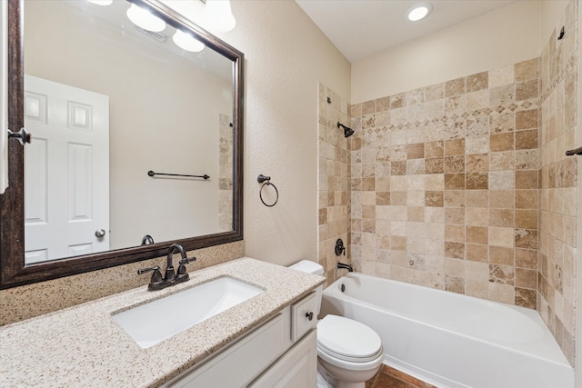 bathroom featuring  shower combination, a textured wall, vanity, and toilet