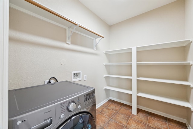 laundry area featuring washer / dryer, baseboards, and laundry area