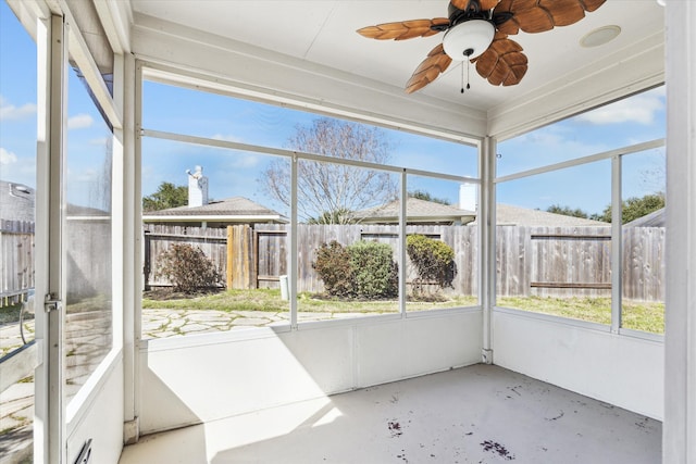 unfurnished sunroom with a ceiling fan