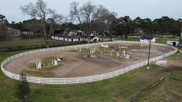 surrounding community featuring an enclosed area and a rural view