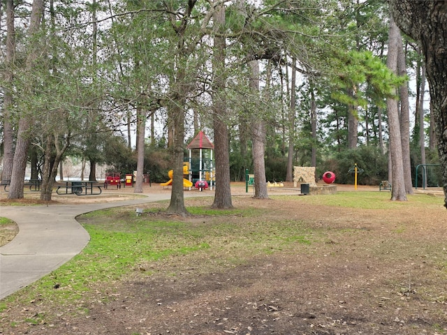 view of home's community with playground community and driveway