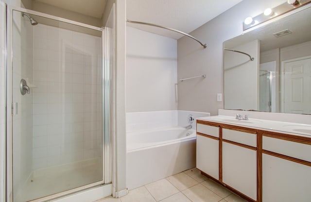 bathroom featuring tile patterned flooring, vanity, and plus walk in shower