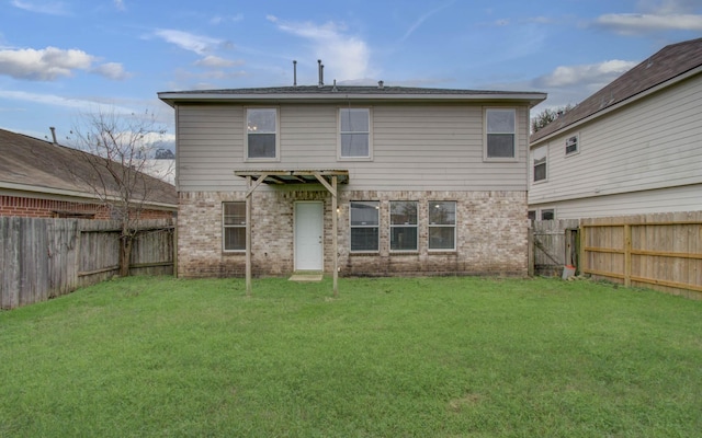 rear view of house with a lawn