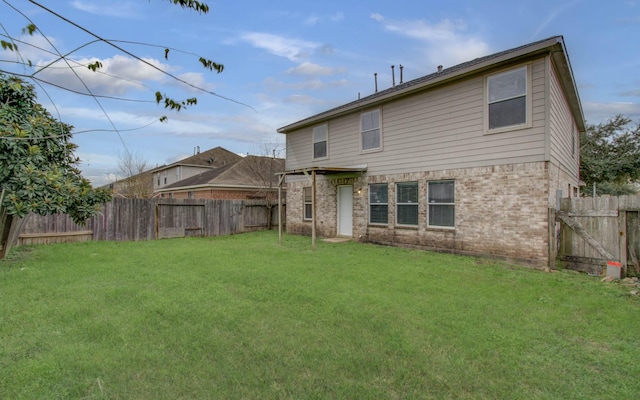 back of house with a lawn