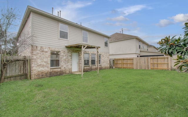 back of house featuring a yard