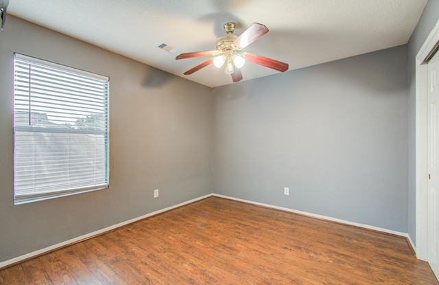 unfurnished room with hardwood / wood-style floors and ceiling fan